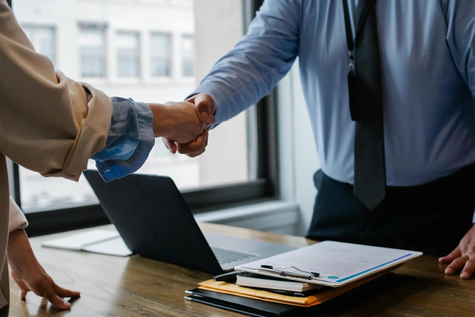 Man and woman shaking hands professionally