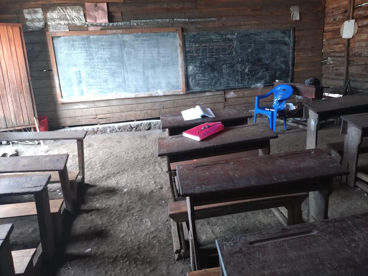 Empty classroom with desks and a blackboard