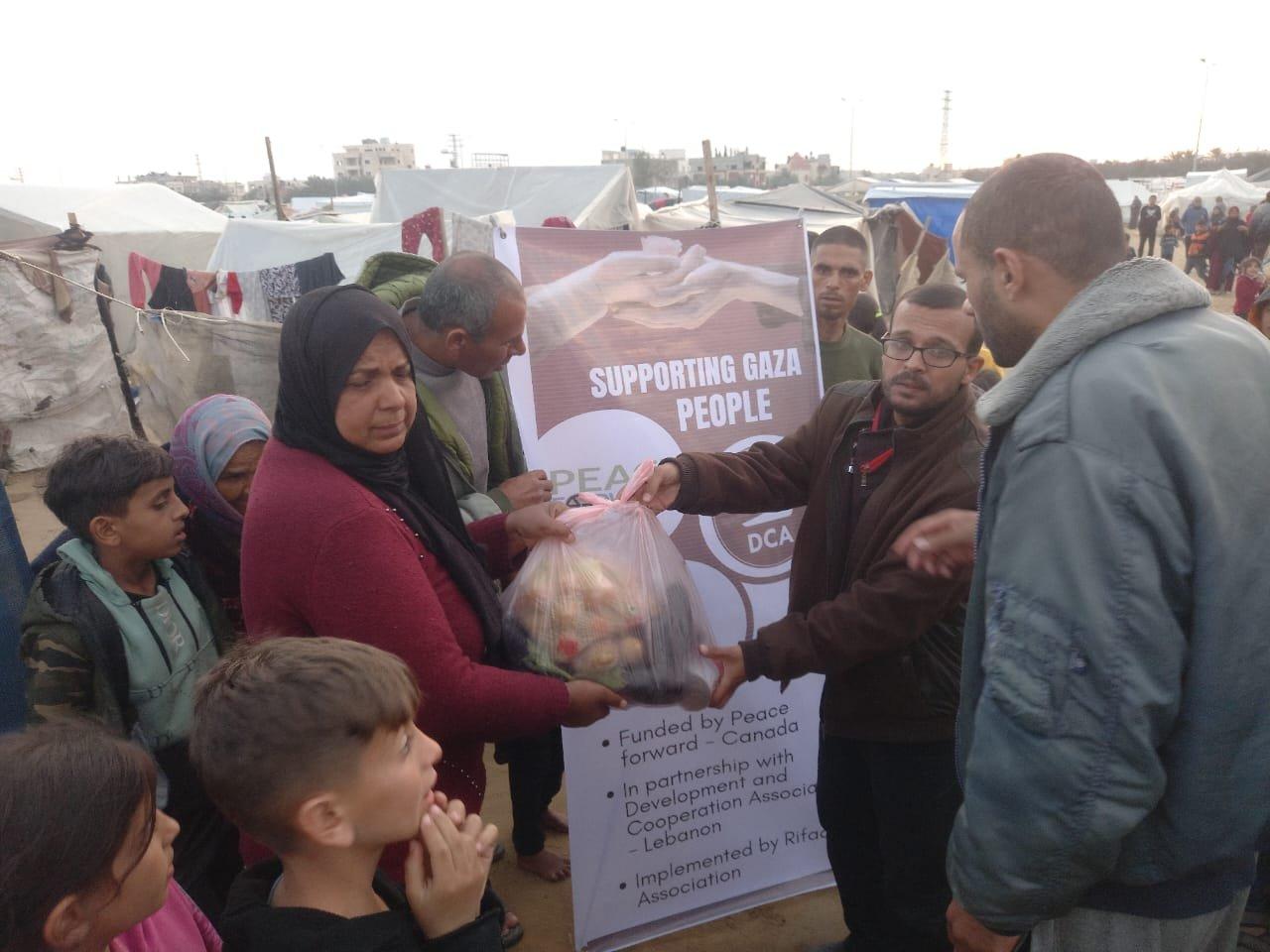 Man distributing food to people in gaza