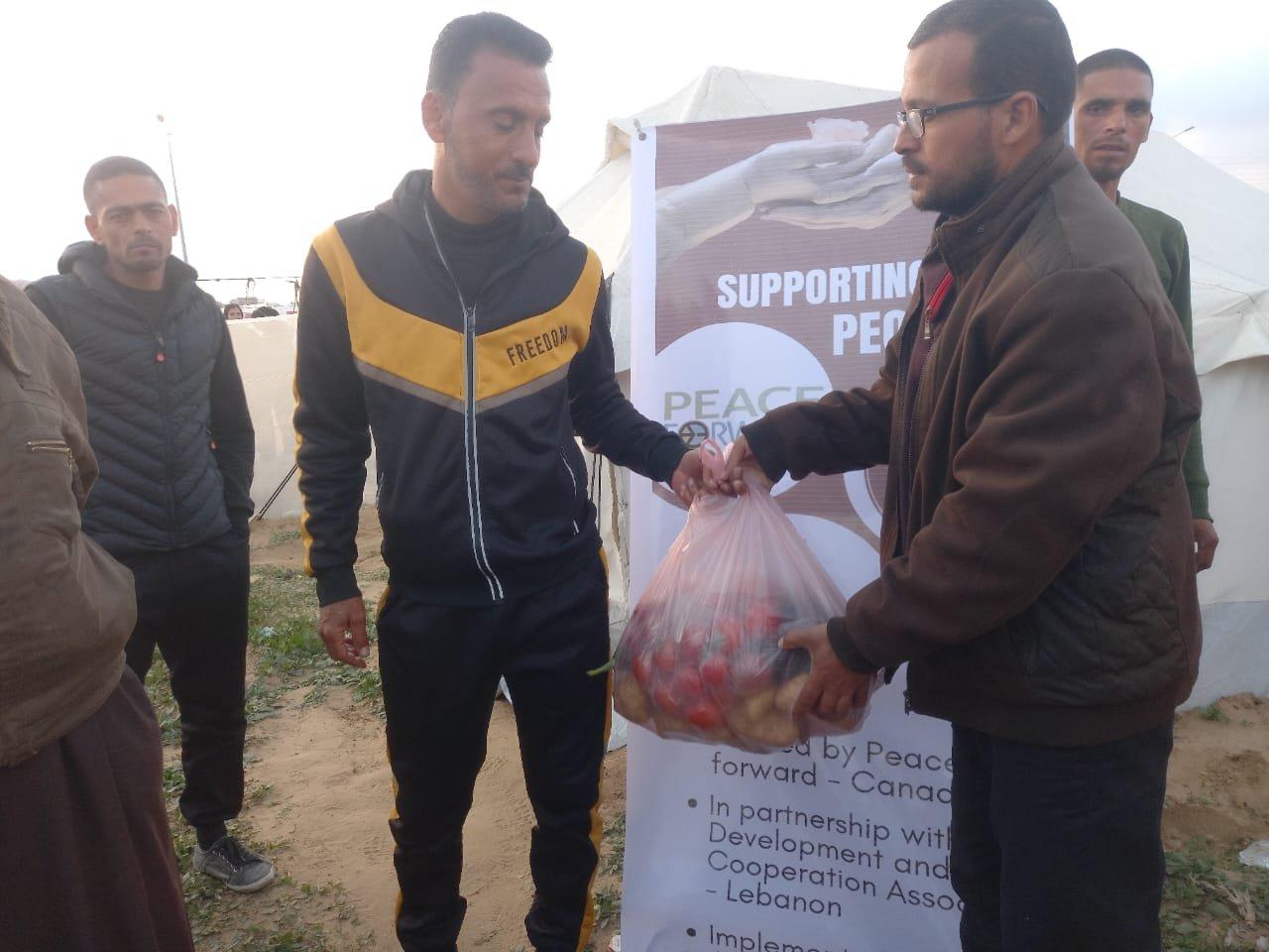 Man distributing food to people in gaza