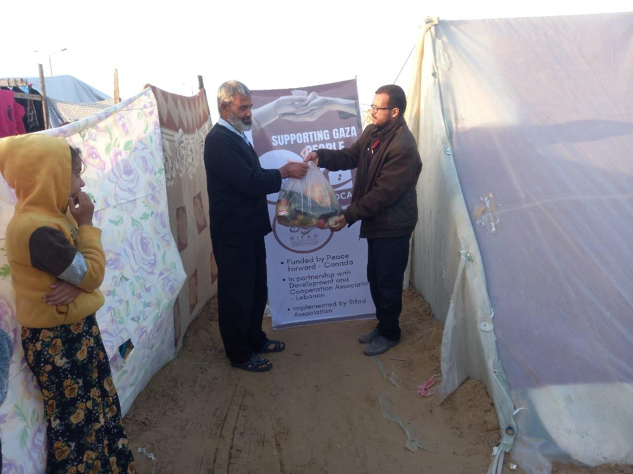 Man distributing food to people in gaza