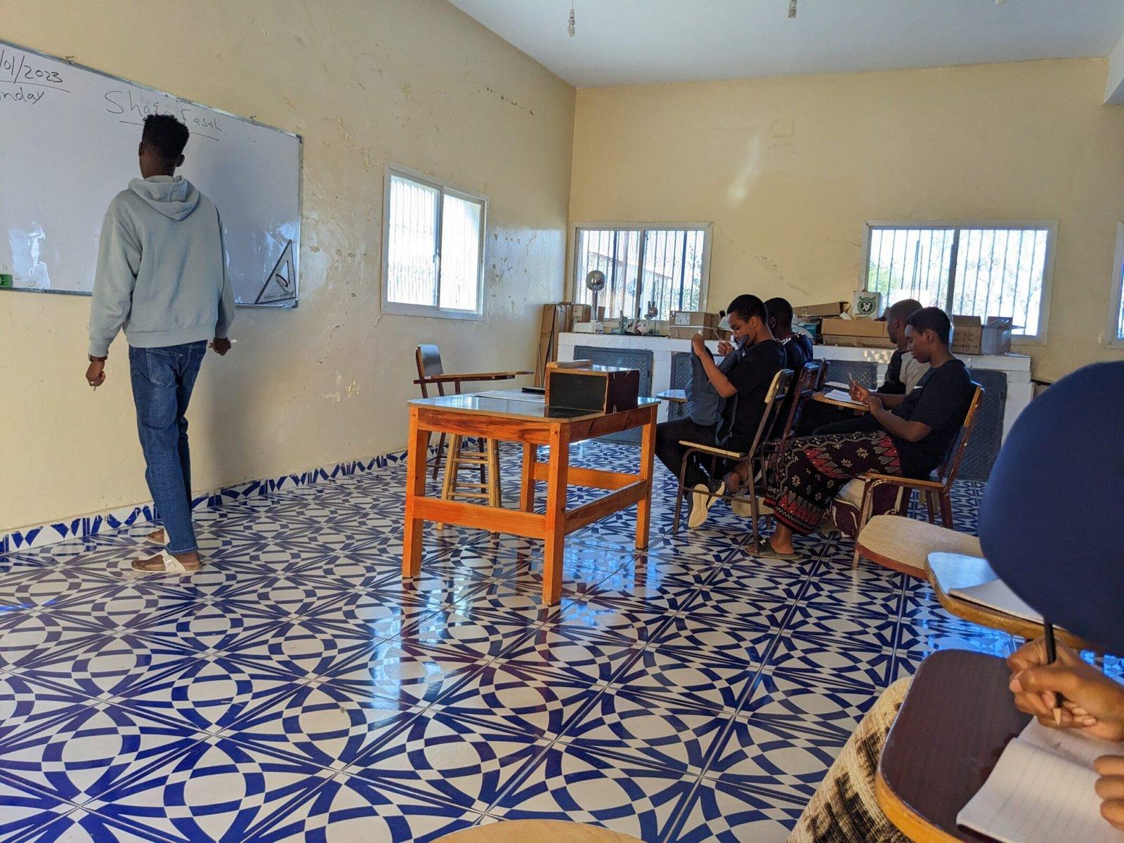 Teacher and young boy students in the classroom