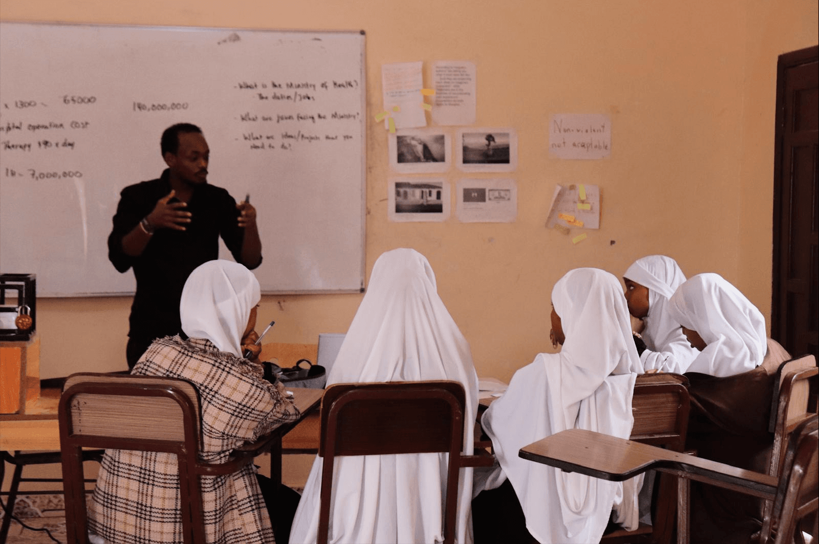 Teacher and young girl students in the classroom